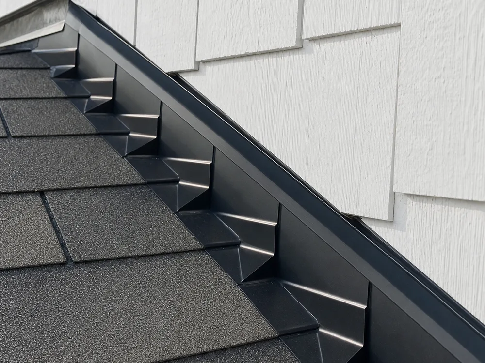 Properly installed step flashing and counterflashing at a roof-to-wall intersection